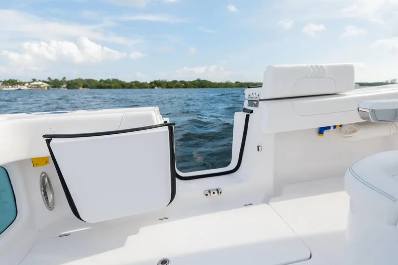 Slide: The Image of Manufacturer Provided Image: Phenom 37 boat interior, 2025 model, with open side door and scenic water view. - 17