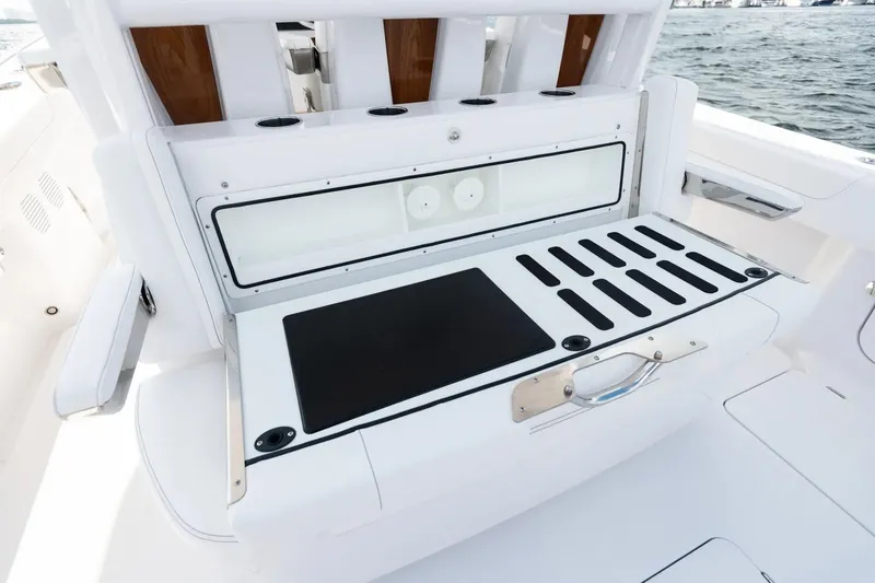 Slide: The Image of Manufacturer Provided Image: Phenom 37 boat interior, 2025 model, featuring a sleek white seating area by the water. - 18