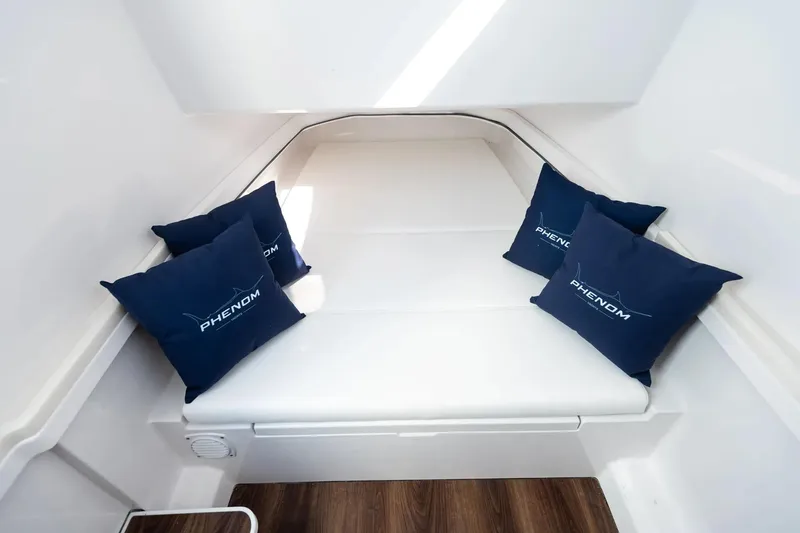 Slide: The Image of Manufacturer Provided Image: Luxurious cabin interior of 2025 Phenom 37 boat with branded cushions. - 21