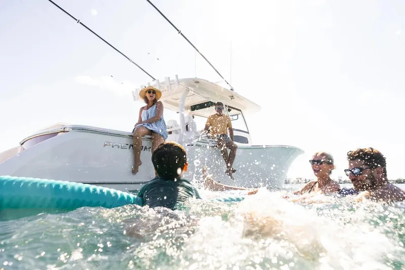 Slide: The Image of Manufacturer Provided Image: People enjoying water near a 2025 Phenom 37 boat under sunny skies. - 3