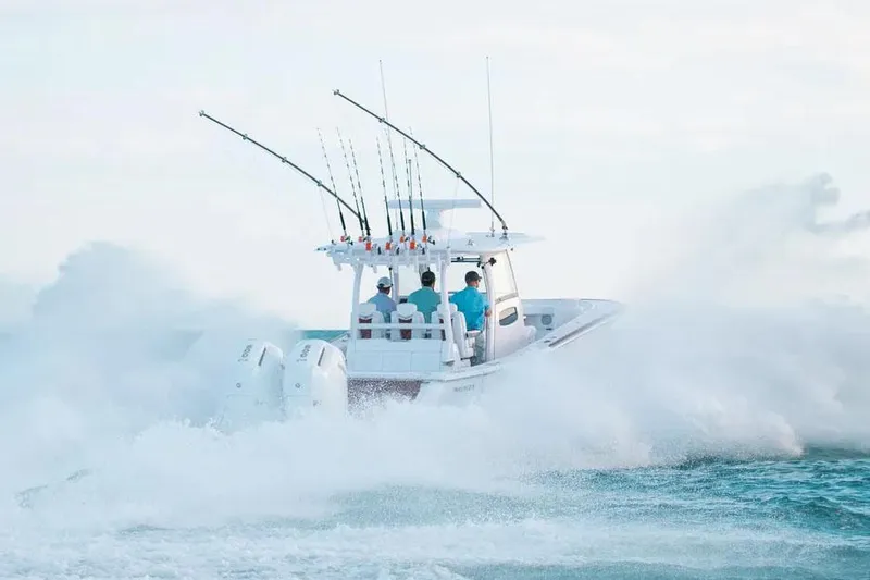 Slide: The Image of Manufacturer Provided Image: 2025 Phenom 37 boat navigating through ocean waves with fishing rods. - 4
