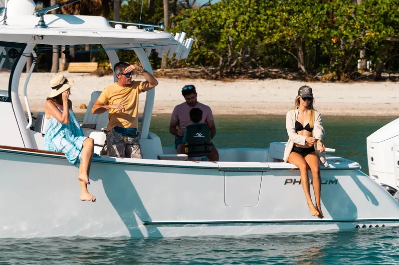 Slide: The Image of Manufacturer Provided Image: People relaxing on a 2025 Phenom 37 boat near a tropical beach. - 5