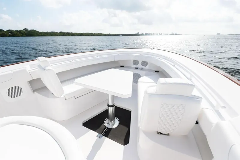Slide: The Image of Manufacturer Provided Image: Luxurious 2025 Phenom 37 yacht interior with white seating and table, overlooking serene waters. - 8