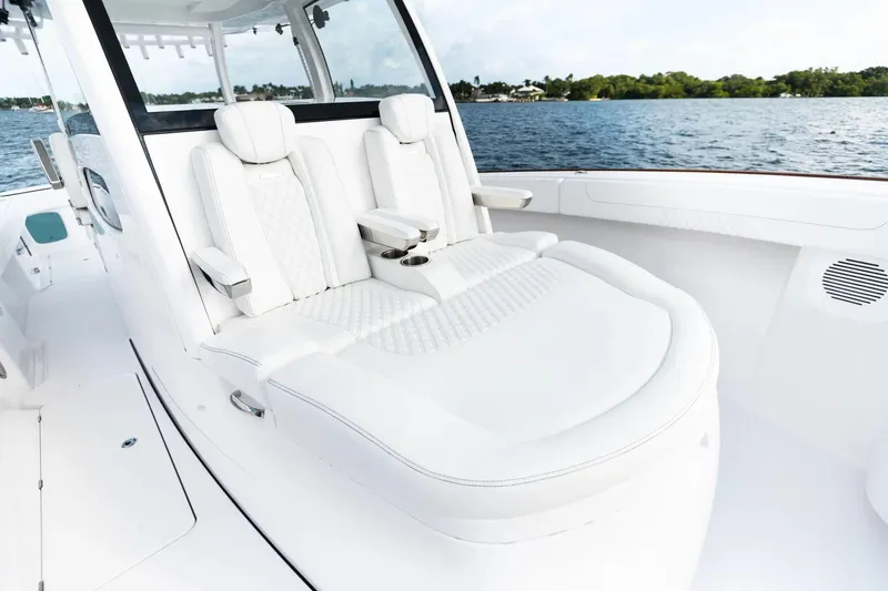 Slide: The Image of Manufacturer Provided Image: Luxurious seating on 2025 Phenom 37 boat, featuring sleek white design and scenic water backdrop. - 9