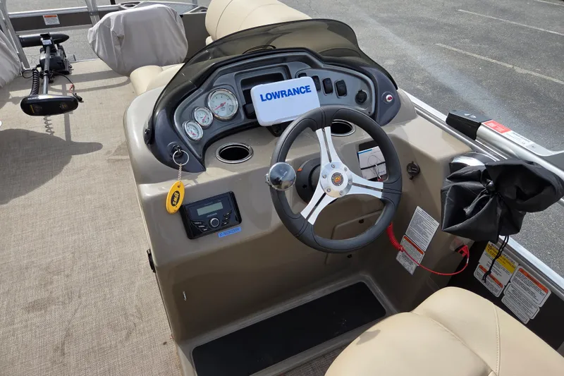 Slide: The Image of 2023 Sun Tracker Fishin' Barge 20 DLX dashboard with steering wheel and control panel. - 7