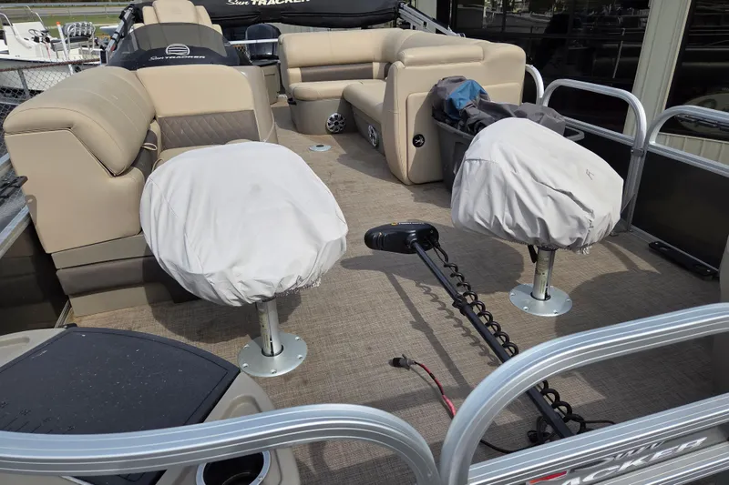 Slide: The Image of 2023 Sun Tracker Fishin' Barge 20 DLX interior with covered seats and fishing equipment. - 9