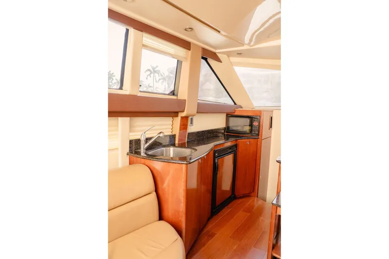 Slide: The Image of Luxurious interior of 2008 Meridian 341 Sedan yacht with kitchenette and seating area. - 11