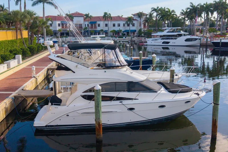 Slide: The Image of 2008 Meridian 341 Sedan Yacht docked in marina with palm trees. - 4