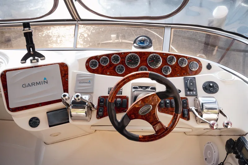 Slide: The Image of 2008 Meridian 341 Sedan helm with Garmin navigation and wood-accented controls. - 7