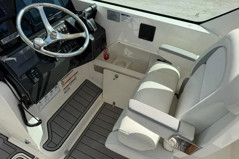 Slide: The Image of 2021 Pursuit DC 266 Dual Console helm with steering wheel and comfortable seating. - 15