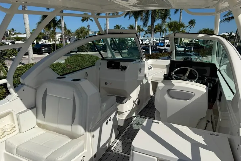 Slide: The Image of 2021 Pursuit DC 266 Dual Console boat interior with seating and steering wheel. - 16