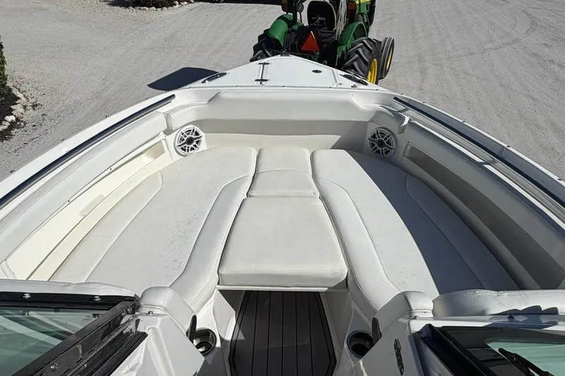 Slide: The Image of 2021 Pursuit DC 266 Dual Console boat with spacious white seating and speakers. - 17