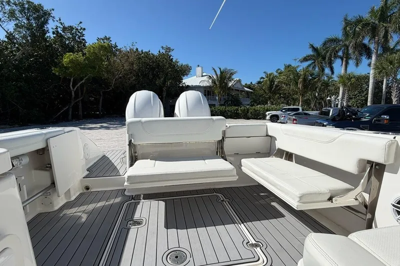 Slide: The Image of 2021 Pursuit DC 266 Dual Console boat interior with seating and outboard motors. - 6
