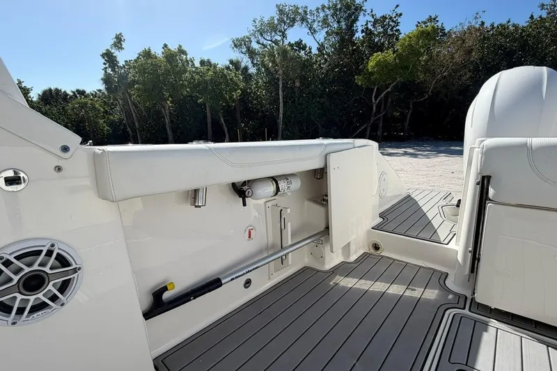 Slide: The Image of 2021 Pursuit DC 266 Dual Console boat interior with seating and storage compartments. - 8