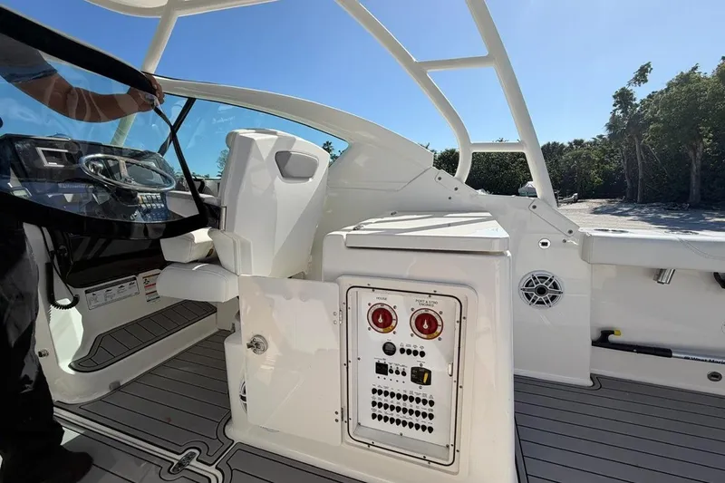 Slide: The Image of 2021 Pursuit DC 266 Dual Console boat interior with control panel and seating. - 9