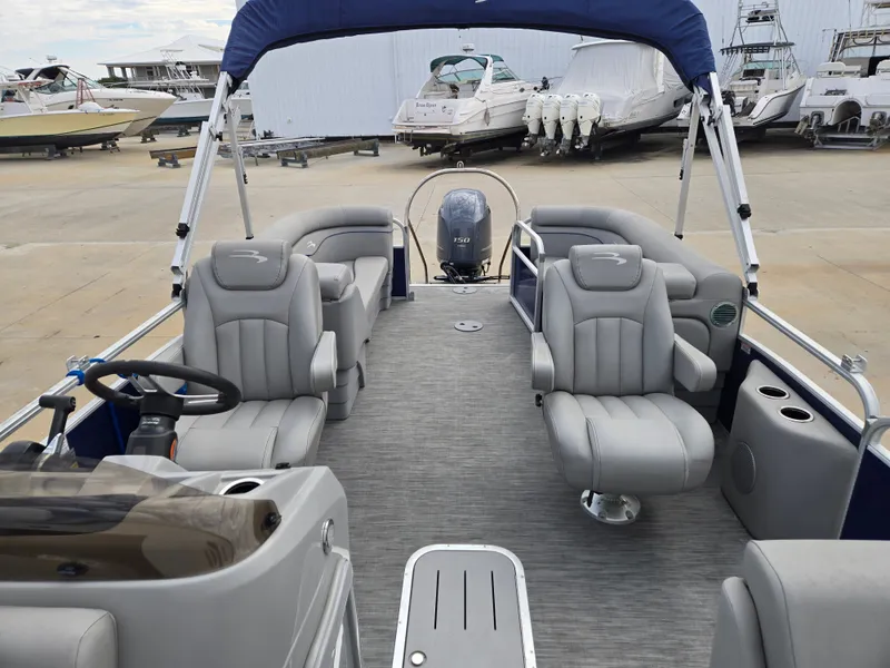 Slide: The Image of Interior view of a 2022 Bennington 22SVSRST pontoon boat at the dock. - 4