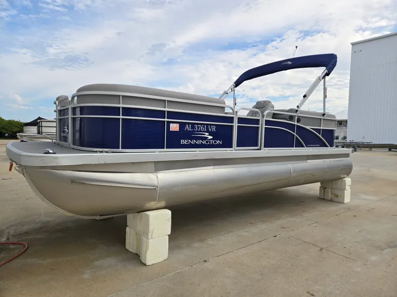 Slide: The Image of 2022 Bennington 22SVSRST pontoon boat on concrete blocks. - 6