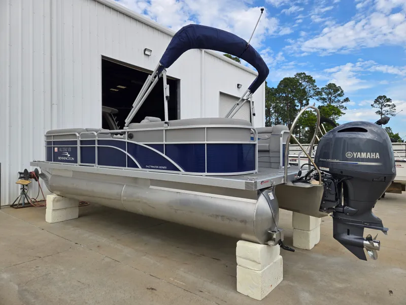 Slide: The Image of 2022 Bennington 22SVSRST pontoon boat with Yamaha engine, parked outside a building. - 7