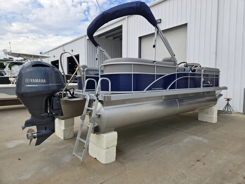 Slide: The Image of 2022 Bennington 22SVSRST pontoon boat with Yamaha motor, parked outside a building. - 8