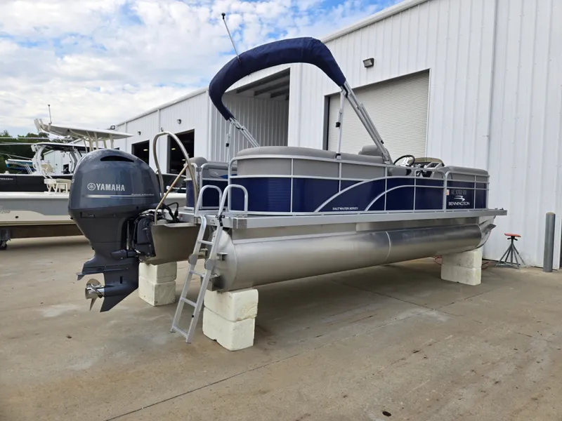 Slide: The Image of 2022 Bennington 22SVSRST pontoon boat with Yamaha motor, stored on concrete blocks. - 9