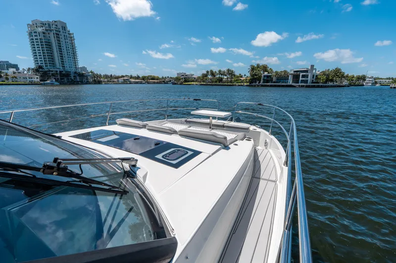 Slide: The Image of 2024 Jeanneau NC 1295 Fly yacht cruising on a sunny day with waterfront views. - 27