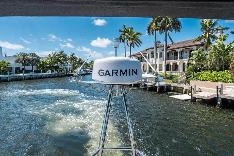 Slide: The Image of 2024 Jeanneau NC 1295 Fly with Garmin equipment, cruising near waterfront homes. - 33