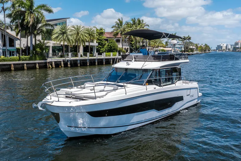 Slide: The Image of 2024 Jeanneau NC 1295 Fly yacht cruising on a sunny waterfront. - 8