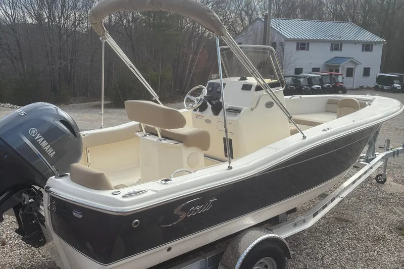 Slide: The Image of 2025 Scout 195 Sportfish boat interior with steering console and seating. - 2