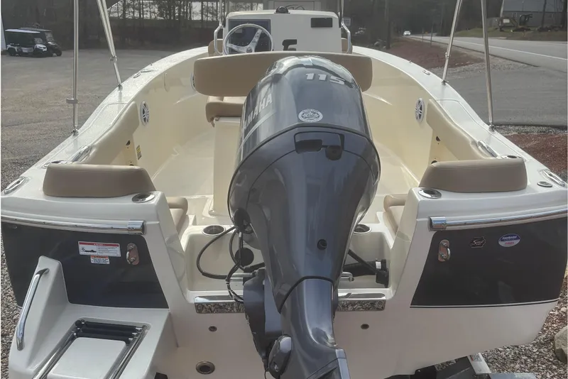 Slide: The Image of 2025 Scout 195 Sportfish boat dashboard with steering wheel and controls. - 3