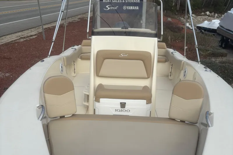 Slide: The Image of 2025 Scout 195 Sportfish boat interior with beige seating and cup holders. - 4