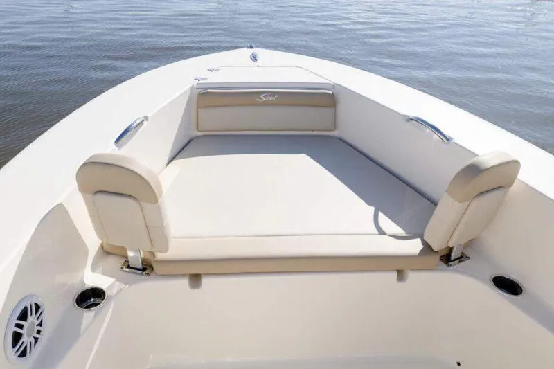 Slide: The Image of 2025 Scout 195 Sportfish boat interior with beige seating and steering wheel. - 5