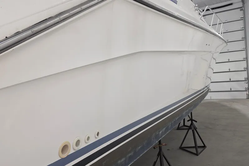 Slide: The Image of 1989 Sea Ray 420 Sundancer boat in storage, side view, on stands. - 12