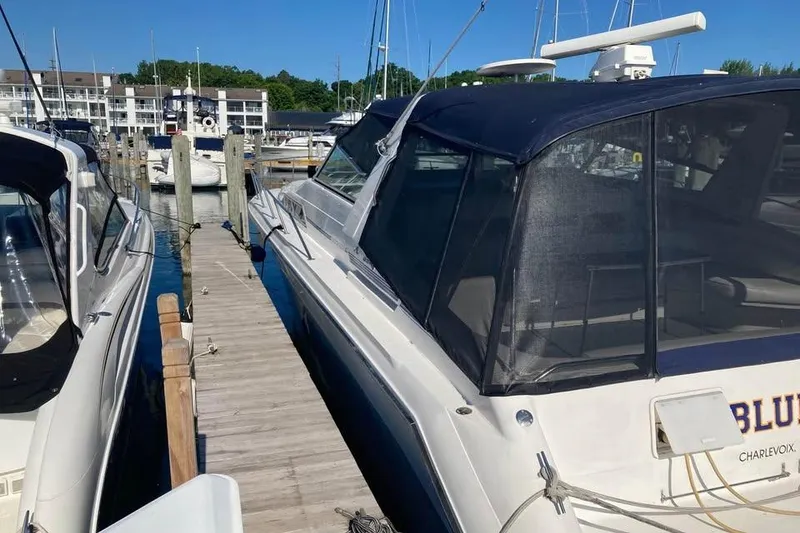 Slide: The Image of 1989 Sea Ray 420 Sundancer docked at marina, sunny day, waterfront view. - 16