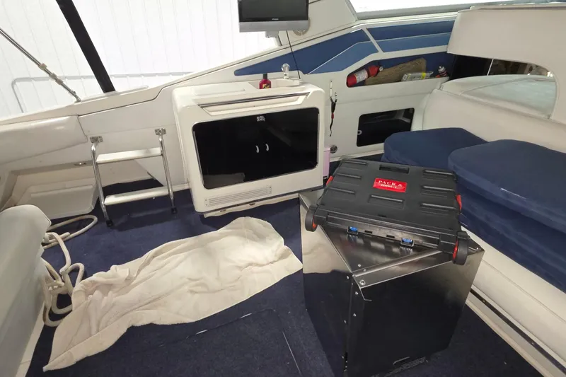 Slide: The Image of Interior of a 1989 Sea Ray 420 Sundancer boat with seating and storage. - 19
