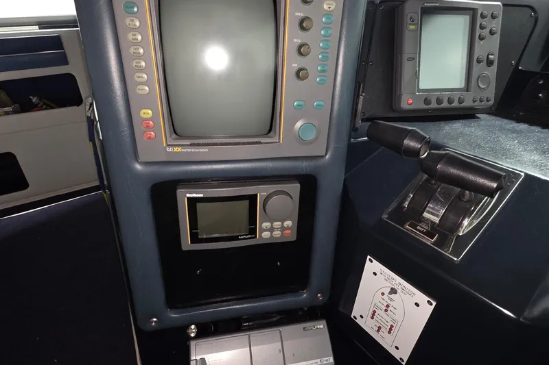 Slide: The Image of Control panel of a 1989 Sea Ray 420 Sundancer with navigation equipment and throttle levers. - 20