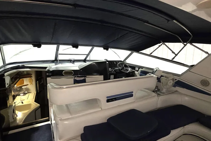 Slide: The Image of Interior of 1989 Sea Ray 420 Sundancer yacht with helm and seating area. - 21