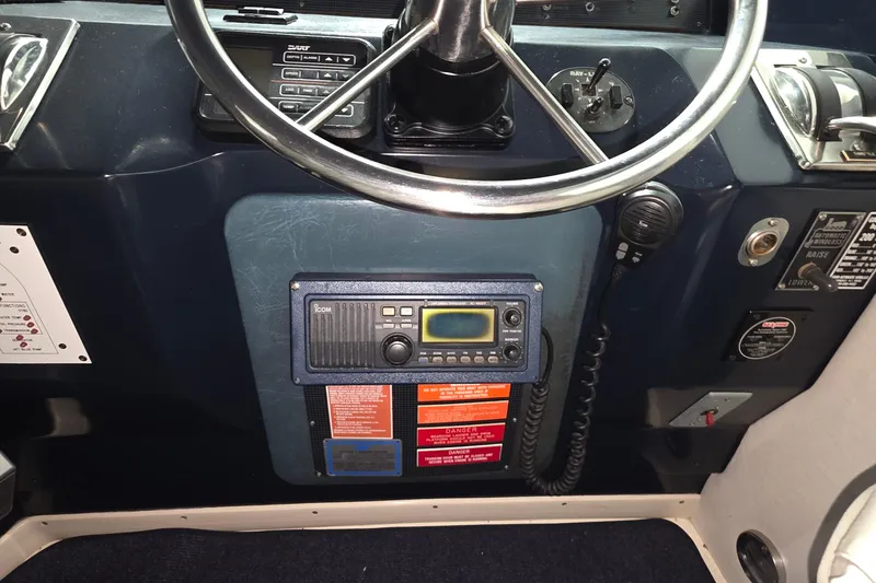 Slide: The Image of Control panel of a 1989 Sea Ray 420 Sundancer boat with steering wheel and radio equipment. - 23