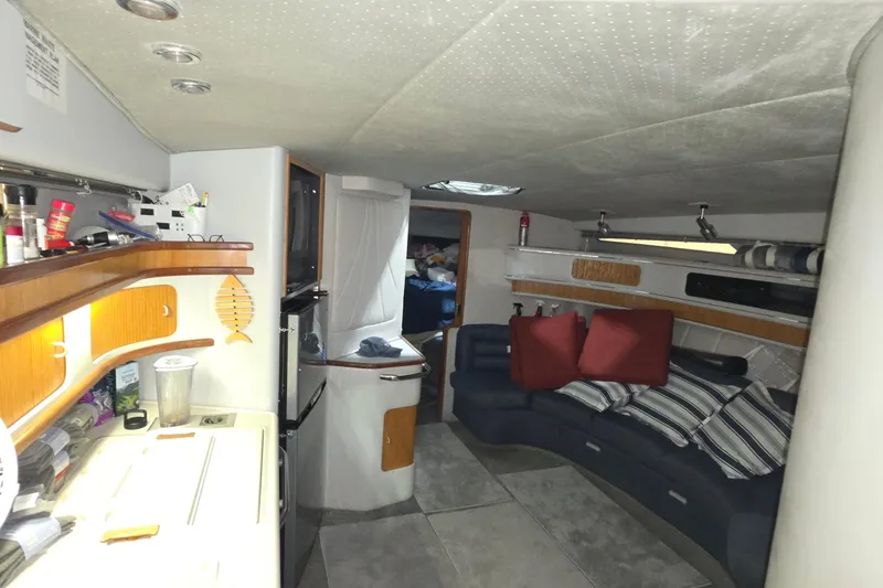 Slide: The Image of Interior of a 1989 Sea Ray 420 Sundancer yacht with cozy seating and kitchenette. - 30