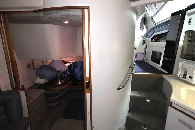 Slide: The Image of Interior of 1989 Sea Ray 420 Sundancer yacht, featuring cabin and stairs. - 32
