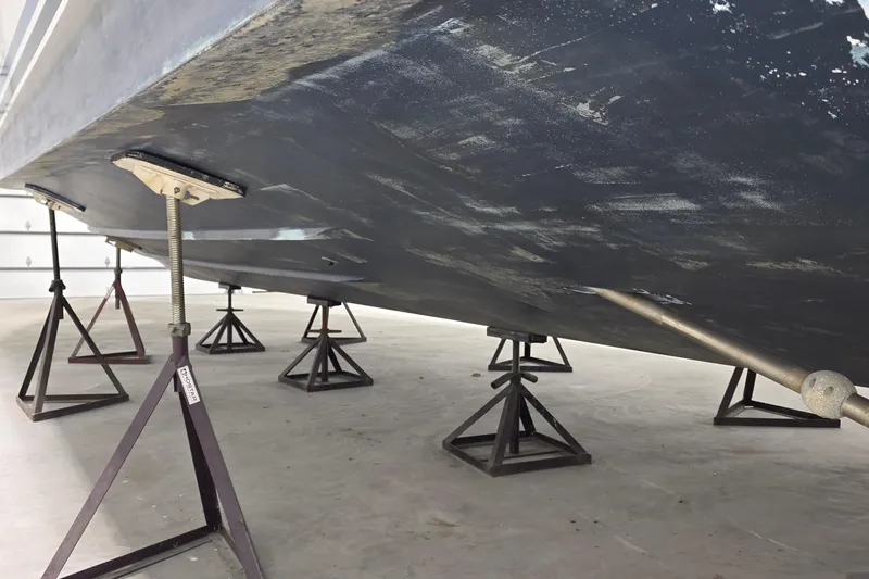 Slide: The Image of Underside of 1989 Sea Ray 420 Sundancer on stands in a garage. - 45