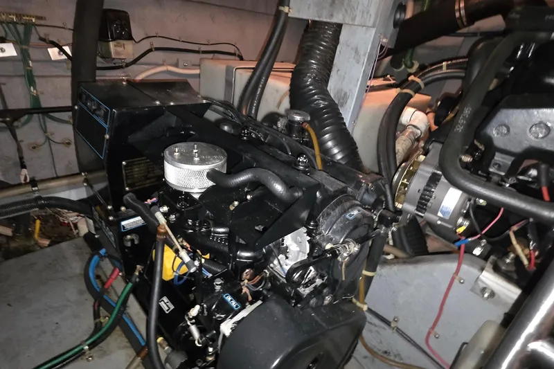 Slide: The Image of Engine room of a 1989 Sea Ray 420 Sundancer with visible mechanical components. - 49