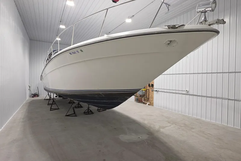 Slide: The Image of 1989 Sea Ray 420 Sundancer yacht stored indoors on stands. - 5