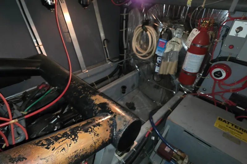 Slide: The Image of Engine room of a 1989 Sea Ray 420 Sundancer boat with fire extinguisher. - 51