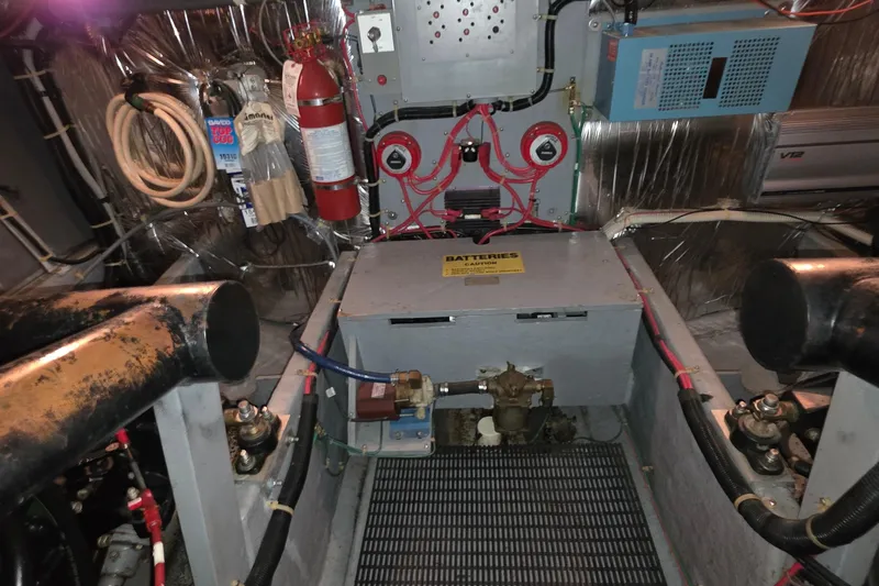 Slide: The Image of Engine room of 1989 Sea Ray 420 Sundancer with wiring, fire extinguisher, and equipment. - 53