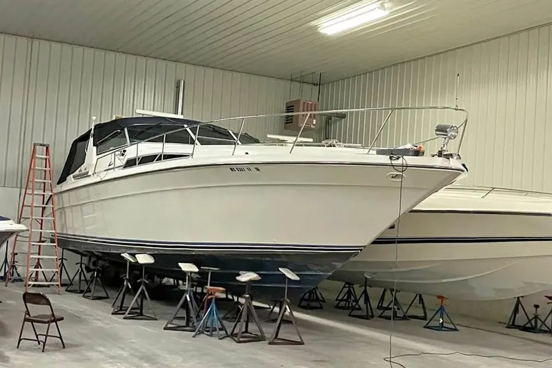 Slide: The Image of 1989 Sea Ray 420 Sundancer yacht stored indoors on stands in a spacious garage. - 6