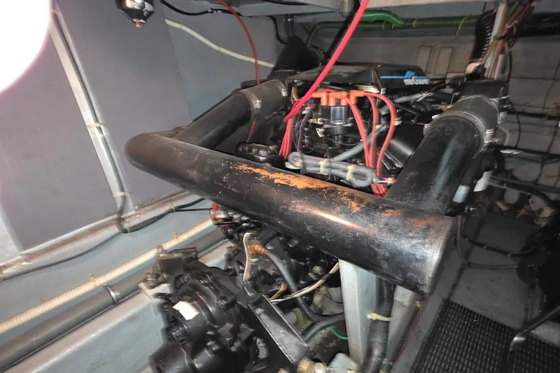 Slide: The Image of Engine room of a 1989 Sea Ray 420 Sundancer boat, showing mechanical components. - 61