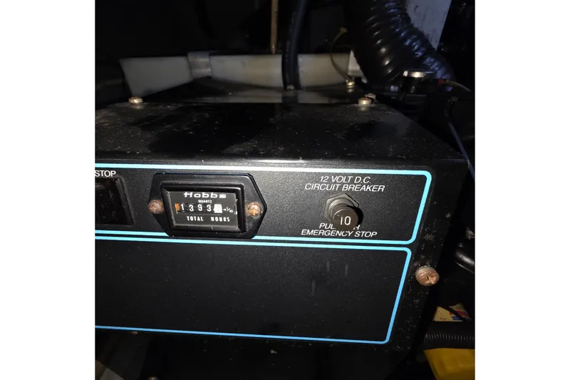 Slide: The Image of Control panel of a 1989 Sea Ray 420 Sundancer with hour meter and circuit breaker. - 69