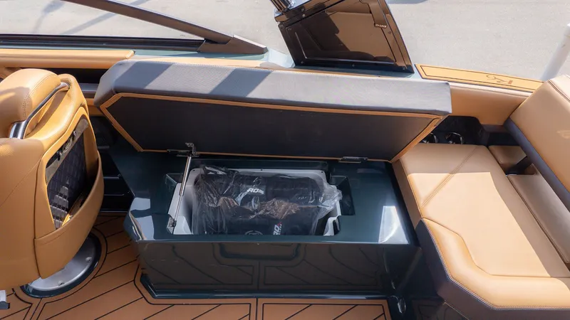 Slide: The Image of Cobalt R6 2026 boat with open storage compartment and leather seating. - 16