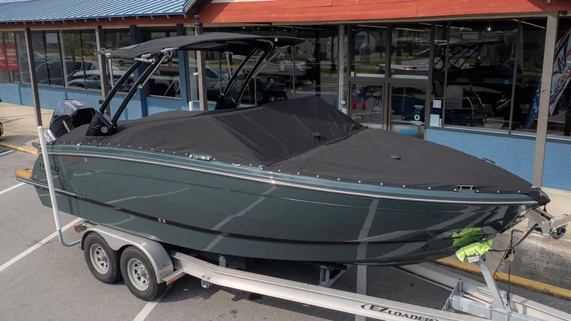 Slide: The Image of 2026 Cobalt R6 boat on trailer outside a store. - 2