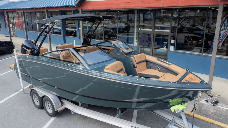 Slide: The Image of 2026 Cobalt R6 boat on trailer outside a store. - 3